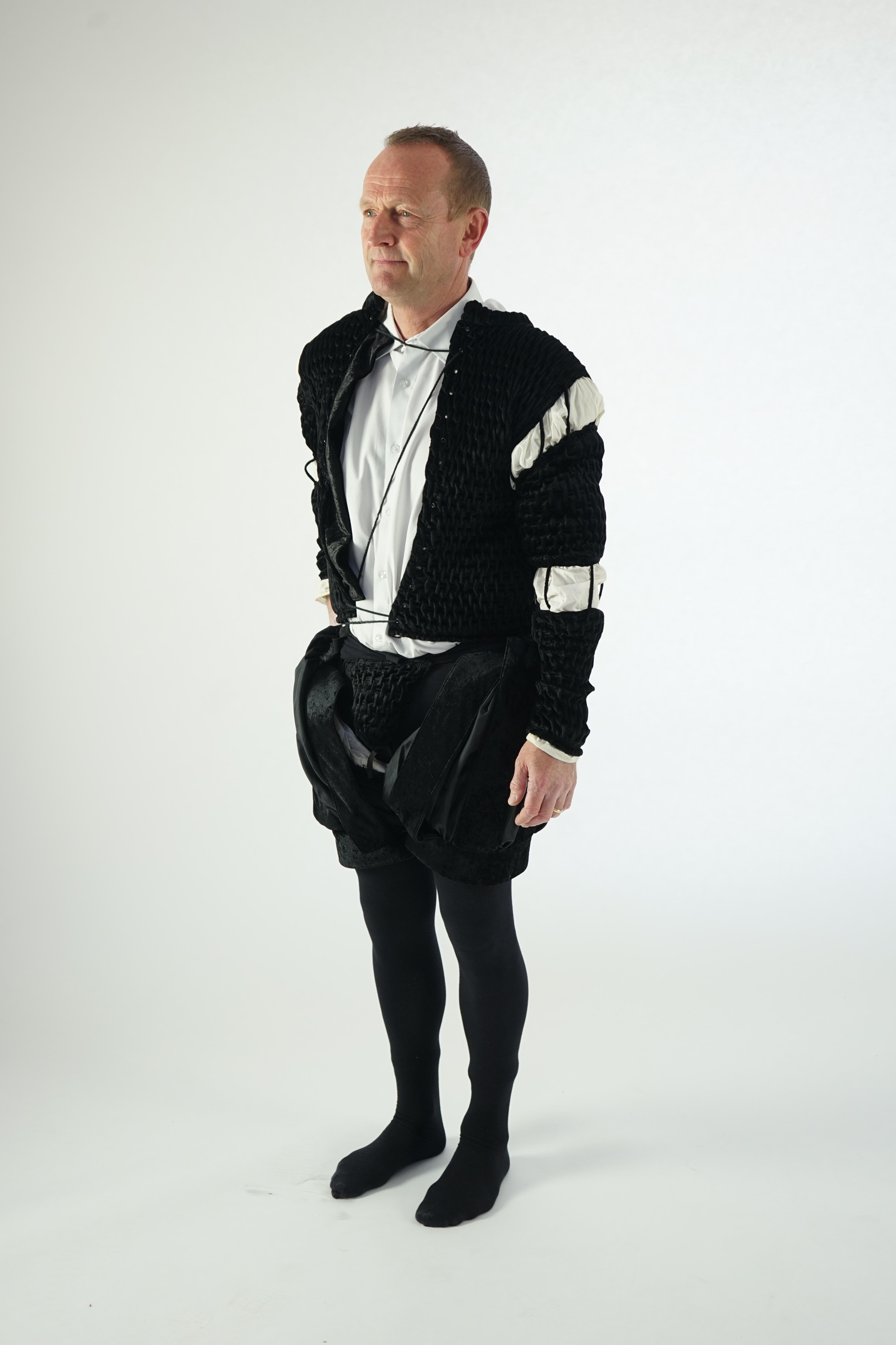 A man's Elizabethan style black smocked velvet and white trim costume, with cod piece and black tights. Ex Royal Opera House Sale.